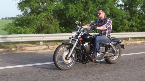 Brutal Man Riding a Motorcycle. Overhead Shot