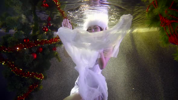 Snow Maiden with Chiffon Skirt Swims Underwater Slow Motion