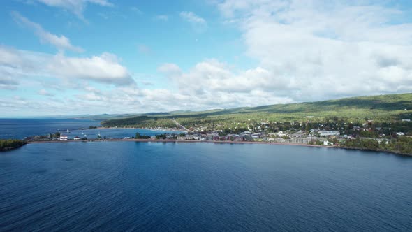 Drone shot over lake superior of Grand Marais on a sunny day in the summer