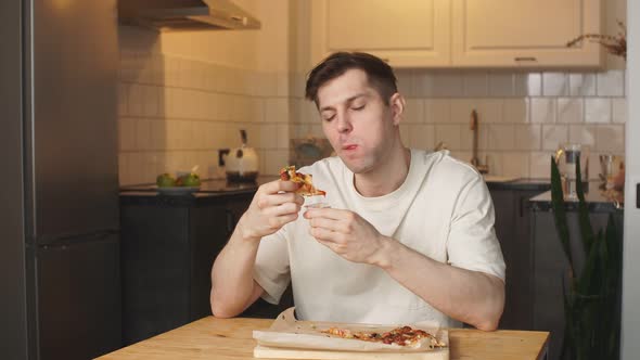 Happy Caucasian Man Eat Pizza at Home.