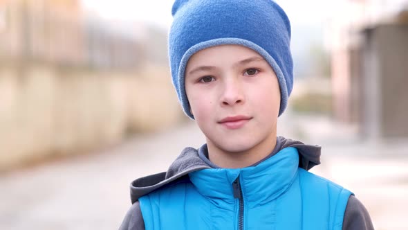 Portrait of Happy Child Boy in Warm Clothes in Autumn Outdoors