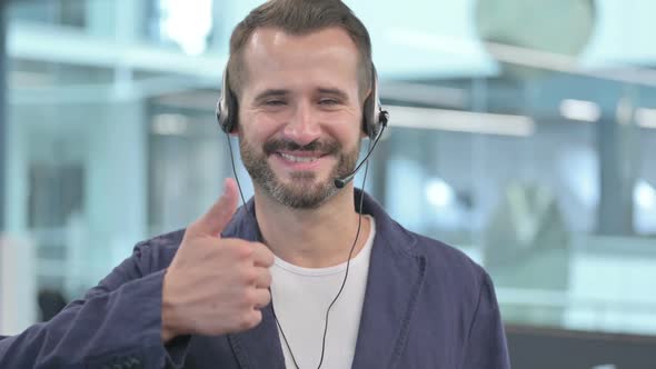 Middle Aged Businessman with Headset Showing Thumbs Up