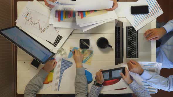 Group of Young Entrepreneurs Plan Future Project Sitting at Table