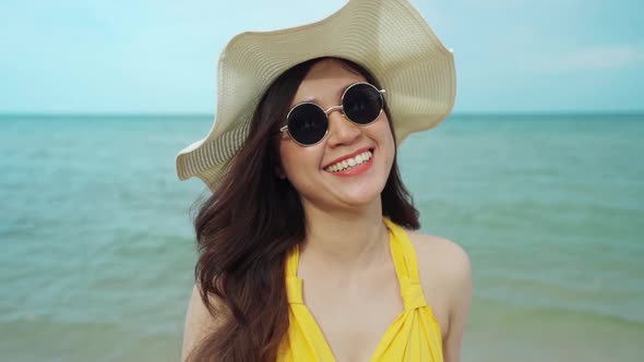 slow-motion of cheerful woman in yellow dress enjoying on the sea beach