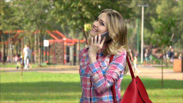Cheerful Caucasian Girl Talking on Cell Phone