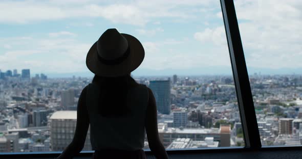 Woman enjoy the view of Tokyo city at observation deck