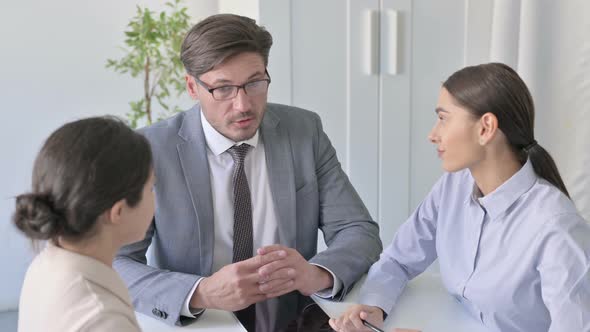 Serious Male and Female Business People having Discussion