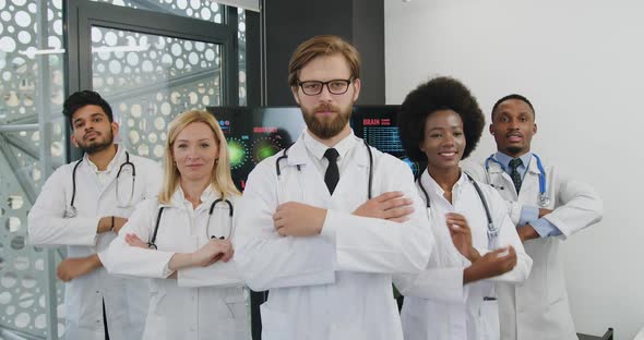 International Team of Medical Coworkers which Posing on Camera with Crossed Arms