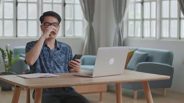 Man Drinking Coffee While Use Phone And Notebook