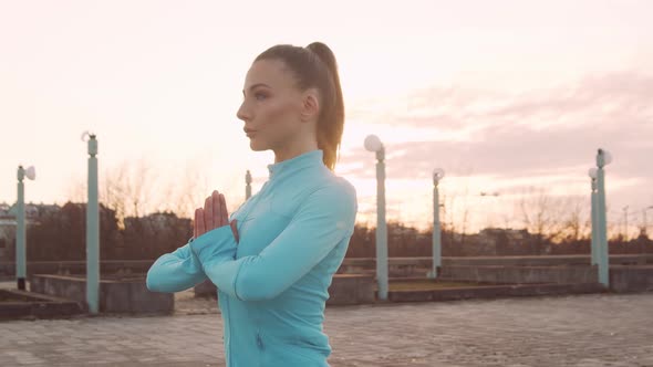 Young, beautiful and sporty woman having evening training outdoor.