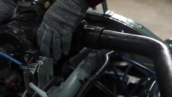 Mechanic Remove the Fuel Pipe Filter From Under the Hood Space of the Car