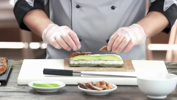 Chef Making Unagi Sushi Roll