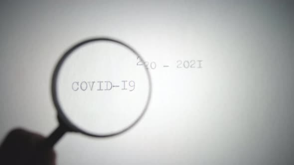 View the inscription covid-19 through a magnifying glass, epidemic.