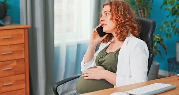 Female in Advanced Pregnancy Spends Break at Office Spins on Swivel Chair Strokes Belly Calls