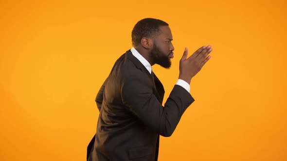 Funny Afro-American Male in Suit Dancing and Pretending to Run, Following Dreams