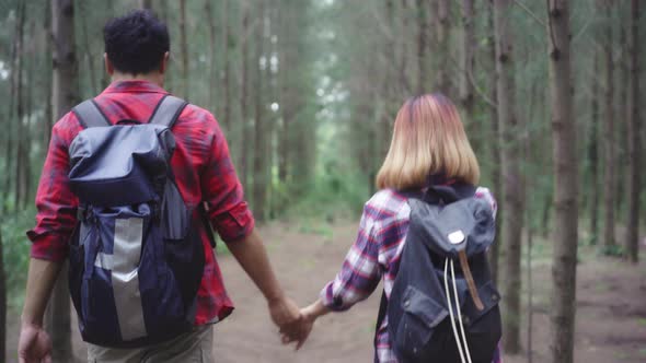 Hiker Asia backpacker couple on hiking adventure feeling freedom walk in forest their holidays.