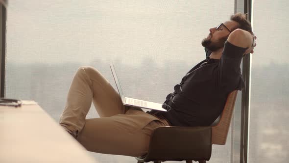 Happy Healthy Stress Free Man Relaxing In Office.Lazy Mindful Peaceful Businessman Leisure In Office