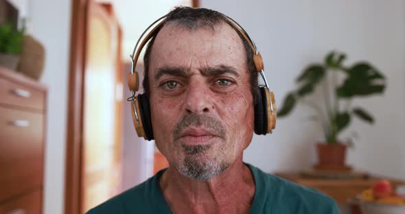 Senior man talking on a video call while wearing headphones