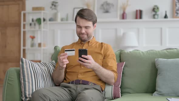 Young Man making Online Payment on Smartphone