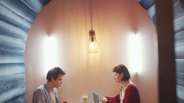 Male and Female Freelancers Working in Modern Coworking Room