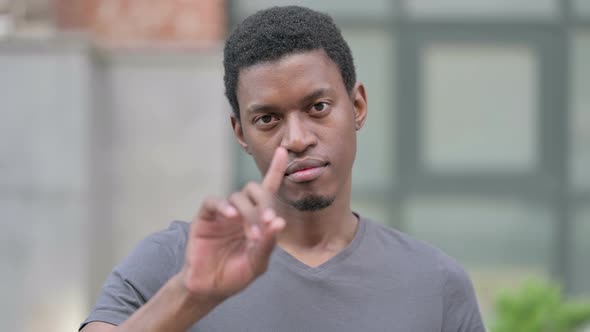 Portrait of Young Young African Man Saying No with Finger Sign