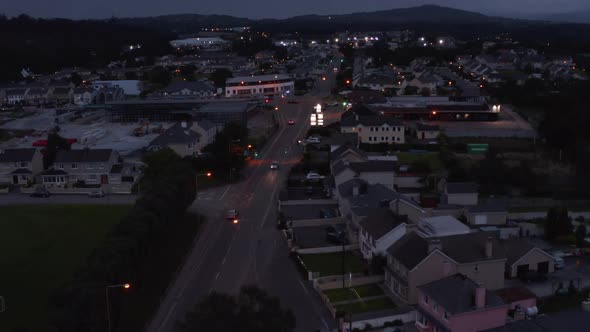 Forward Fly Above Street in Urban Neighbourhood in Evening