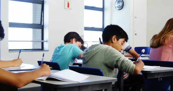 Students doing homework in classroom