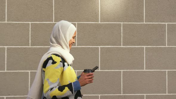 Young woman wearing hijab out and about in the city