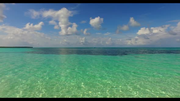 Aerial scenery of marine island beach break by transparent sea with white sandy background of journe