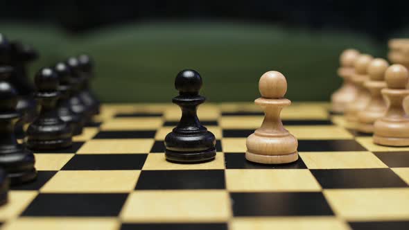 Chess players place white and black pawns on the playing field