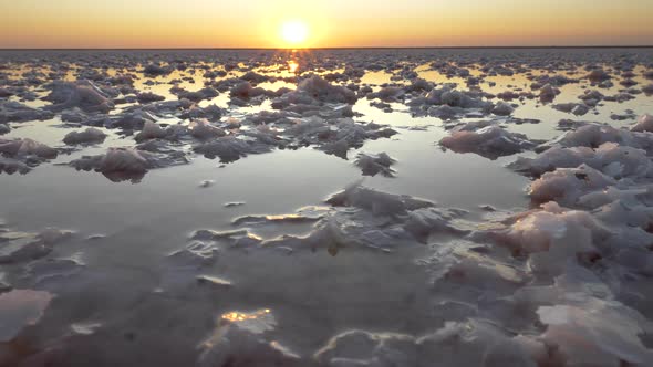 Sunset View of Salt Lake. Steadicam Shot of White Salt and Water. FHD, 