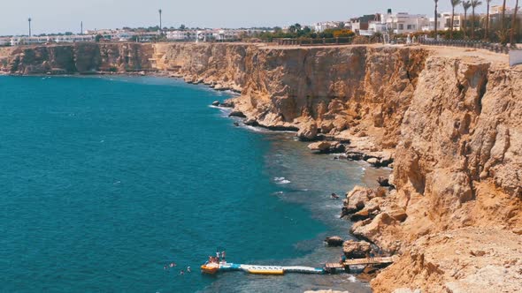 Rocky Beach in Egypt. Beach in a Bay on the Coastline with Waves in the Red Sea and Coral Reefs.