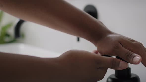 Close up of African-American person washing hands in the sink. Shot with RED helium camera in 8K.