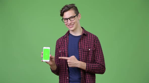 Young Handsome Teenage Nerd Boy Showing Phone