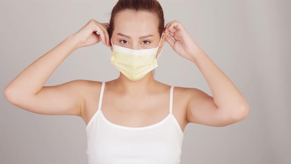 Young happy Asian woman wearing hygienic mask to prevent infection corona virus