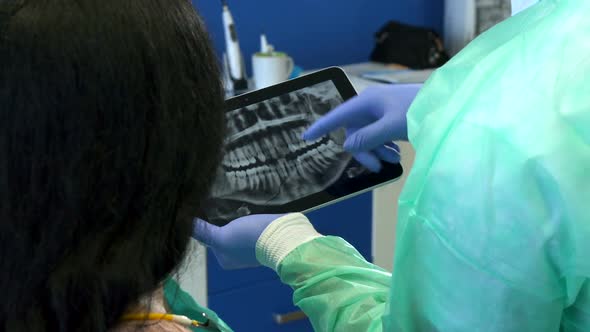 Dentist Zooms X-ray Image on His Tablet
