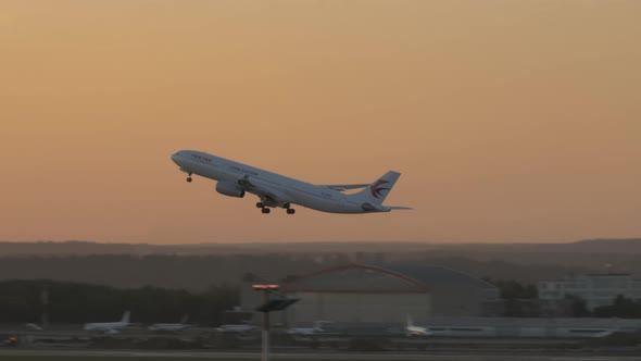 China Eastern airplane A330 taking off at sunset