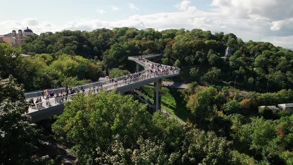 Aerial View of Pedestrian Glass Bridge with a Crowd of Walking People