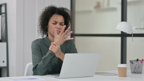 African Woman Having Wrist Pain While Using Laptop