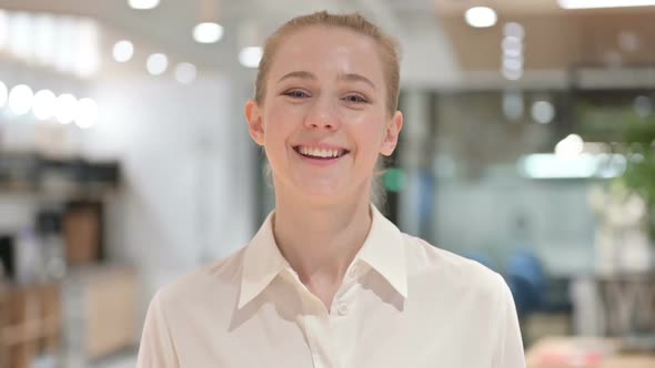 Portrait of Appreciative Businesswoman Saying Yes By Shaking Head