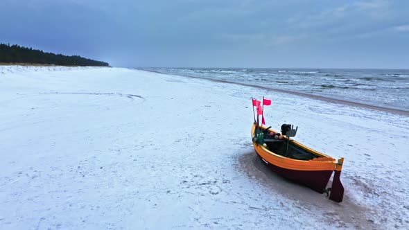 Fishing boats on snowy beach in winter at Baltic sea