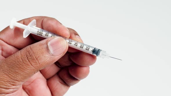 Fingers Hold A Insulin Syringe Needle 