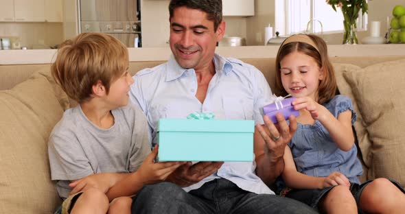 Cute children giving their father presents