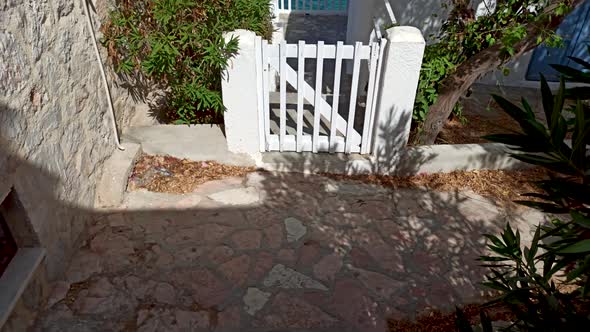 Rhodes, Greece: Tilt up shot of a white entrance gate of a house