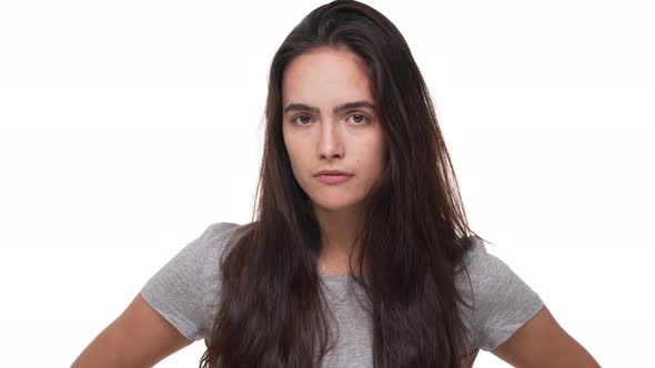 Portrait of Caucasian Young Brunette Woman Being Bored Rolling Her Eyes Isolated Over White