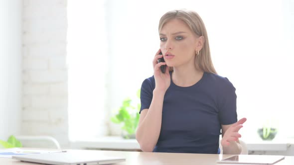 Upset Woman Talking Angrily on Smartphone