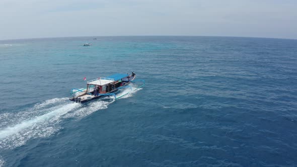 Tourist White and Blue Motorboat Catamaran Sails on Ocean