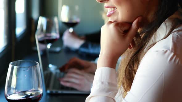 Beautiful woman holding glass of wine in restaurant