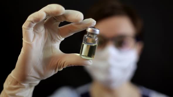 A Doctor or Nurse in Nitrile Gloves Holds in His Hand a Vaccine Vaccinated Against Influenza