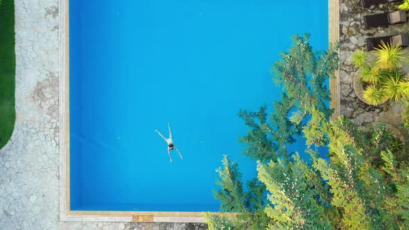 Girl Swims in The Outdoor Pool